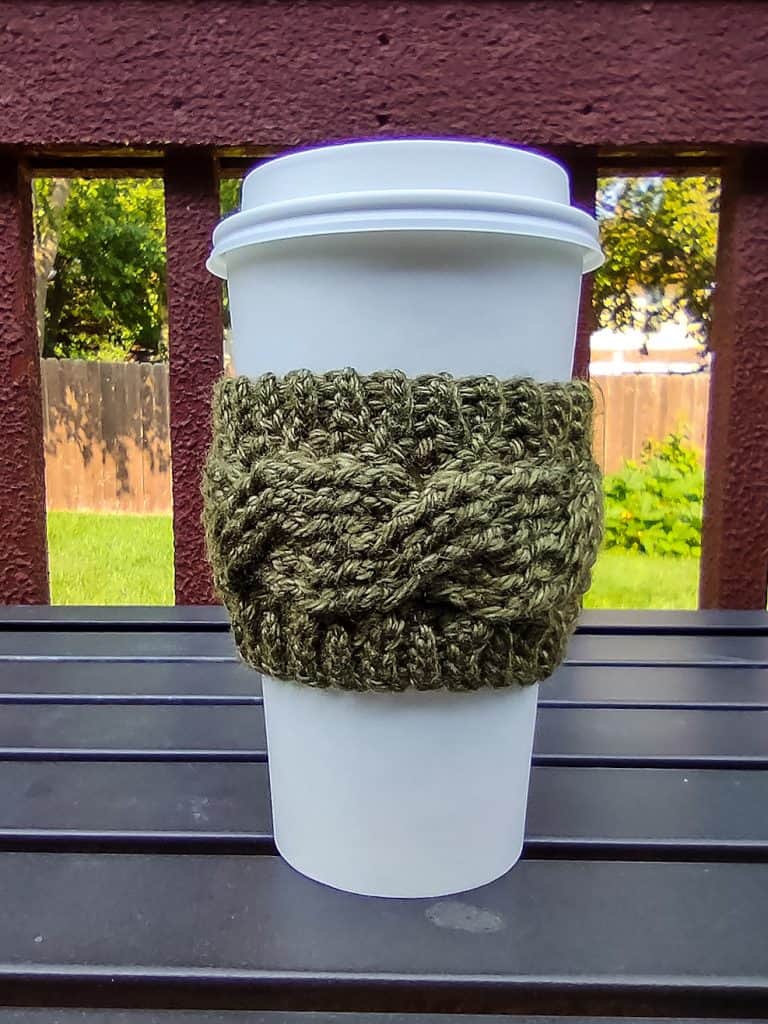green cable cup cozy on white disposable coffee cup